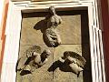 Semi-submerged statues on a building door